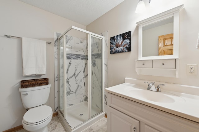 full bathroom with a textured ceiling, vanity, a marble finish shower, and toilet