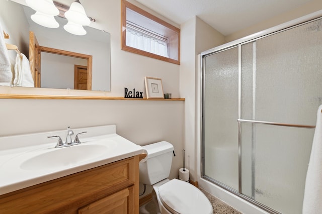 full bath with a shower stall, toilet, and vanity