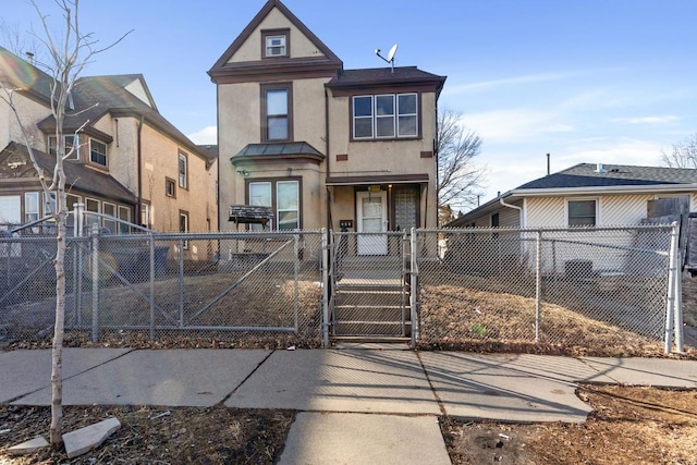 view of front of property featuring a fenced front yard, a gate, and stucco siding