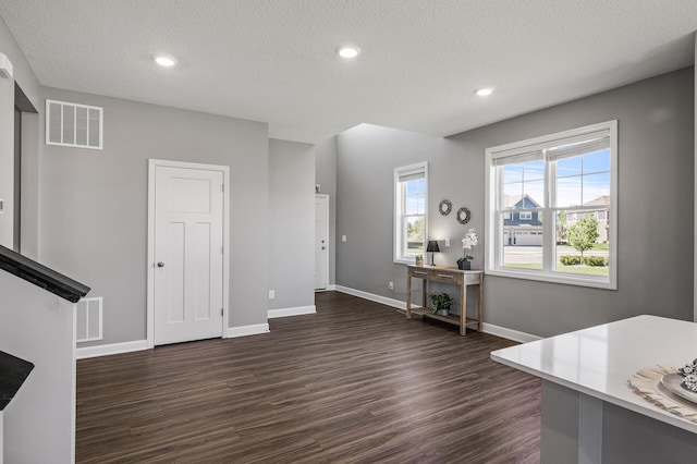 3485 109th Ln NE, Blaine, MN 55449 - unfurnished office featuring dark wood-style flooring, baseboards, a textured ceiling, and recessed lighting