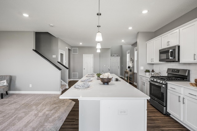3485 109th Ln NE, Blaine, MN 55449 - kitchen featuring stainless steel appliances, a sink, dark wood finished floors, light countertops, and a kitchen island with sink