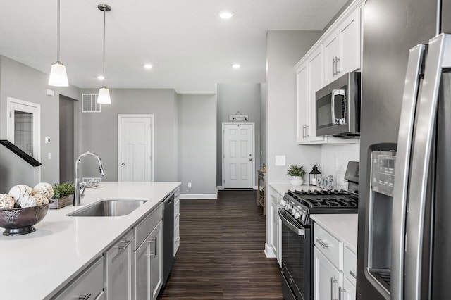3485 109th Ln NE, Blaine, MN 55449 - kitchen with stainless steel appliances, a sink, dark wood-style floors, light countertops, and white cabinets