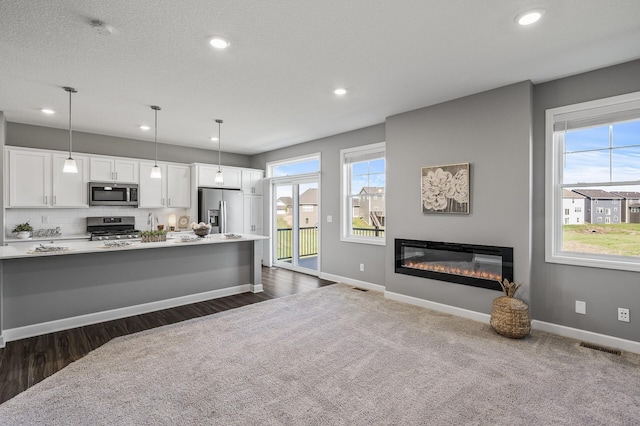 3485 109th Ln NE, Blaine, MN 55449 - kitchen with appliances with stainless steel finishes, healthy amount of natural light, white cabinets, light countertops, and recessed lighting