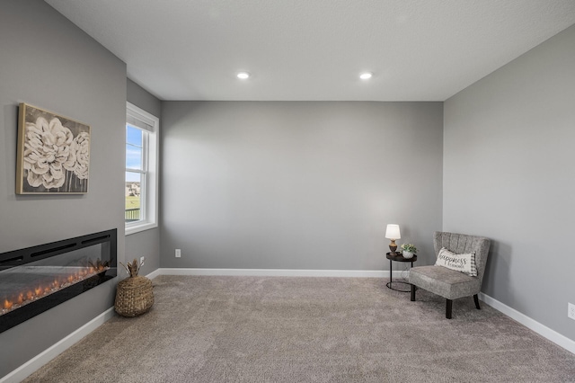 3485 109th Ln NE, Blaine, MN 55449 - living area with carpet, a glass covered fireplace, baseboards, and recessed lighting