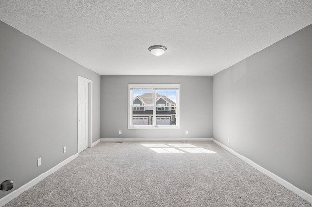 3485 109th Ln NE, Blaine, MN 55449 - unfurnished room featuring carpet, baseboards, and a textured ceiling