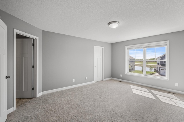 3485 109th Ln NE, Blaine, MN 55449 - unfurnished bedroom with carpet floors, a textured ceiling, and baseboards