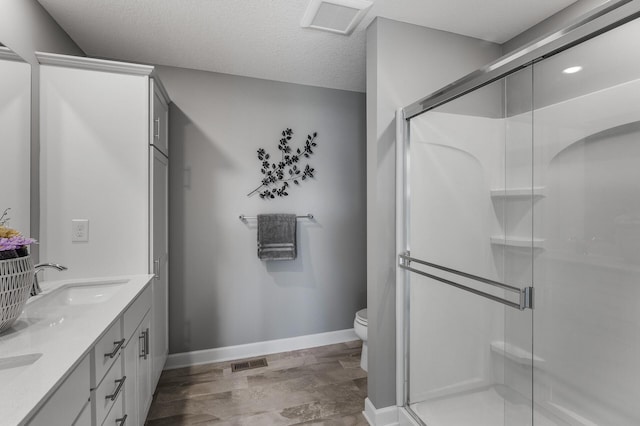 3485 109th Ln NE, Blaine, MN 55449 - full bath with a stall shower, toilet, baseboards, double vanity, and wood finished floors