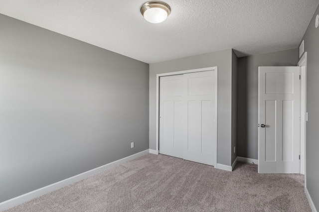 3485 109th Ln NE, Blaine, MN 55449 - unfurnished bedroom featuring carpet, a textured ceiling, a closet, and baseboards