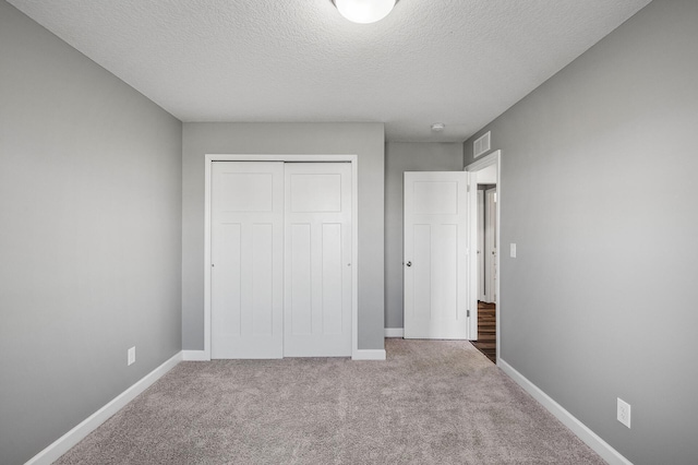 3485 109th Ln NE, Blaine, MN 55449 - unfurnished bedroom with carpet flooring, a textured ceiling, a closet, and baseboards