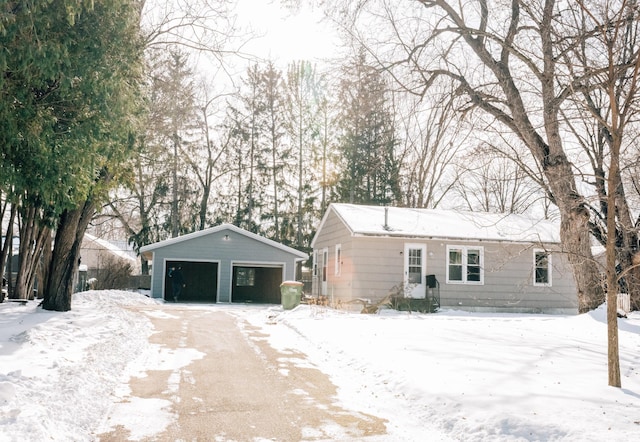 view of front facade featuring a detached garage and an outbuilding