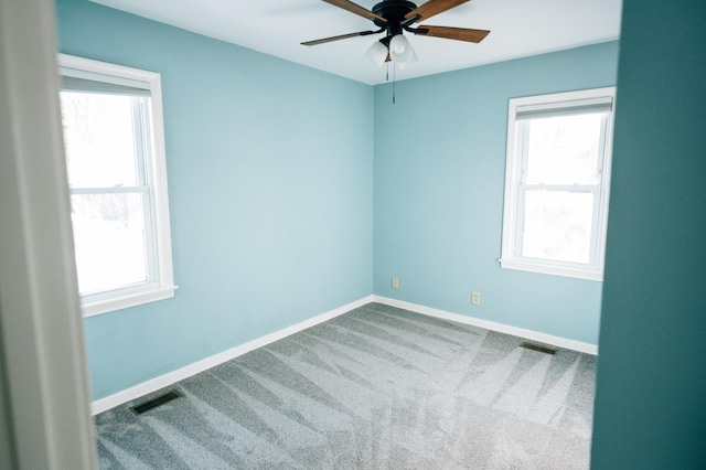 unfurnished room featuring visible vents, baseboards, ceiling fan, and carpet flooring