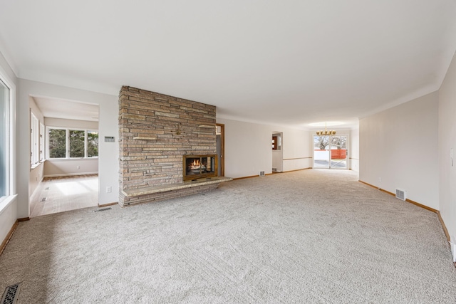 unfurnished living room featuring a stone fireplace, carpet flooring, and visible vents