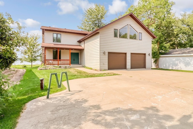 view of front of home featuring an attached garage, driveway, a front lawn, and a porch