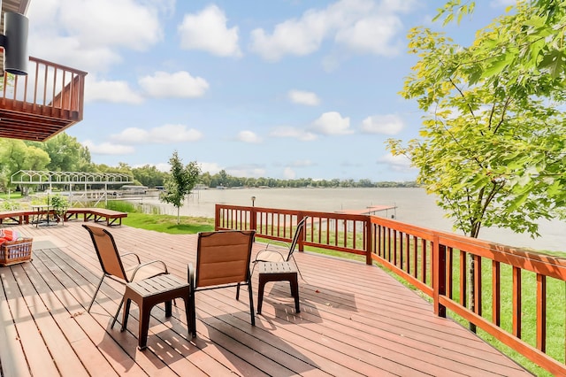 wooden terrace featuring a water view