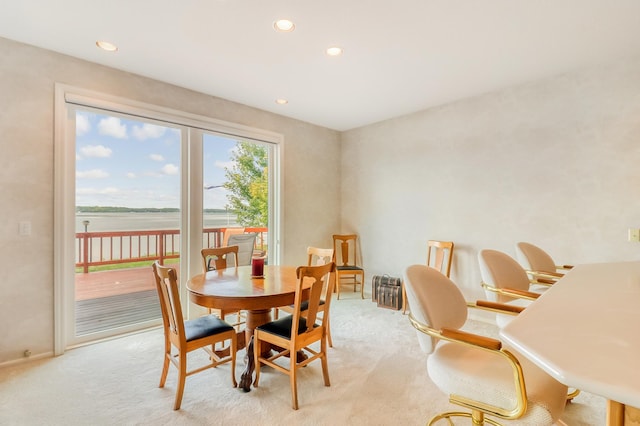 dining room with recessed lighting and light colored carpet