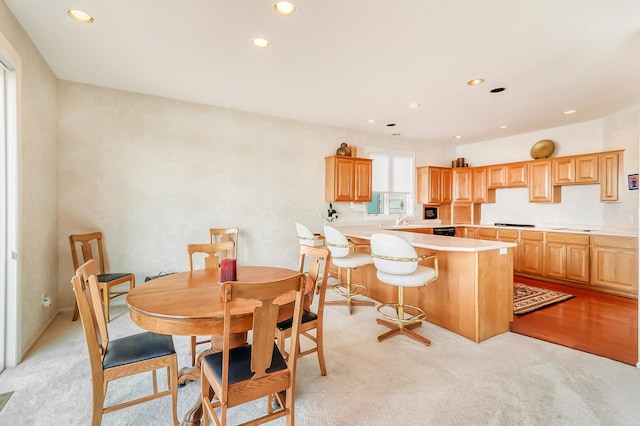 dining space featuring light colored carpet and recessed lighting