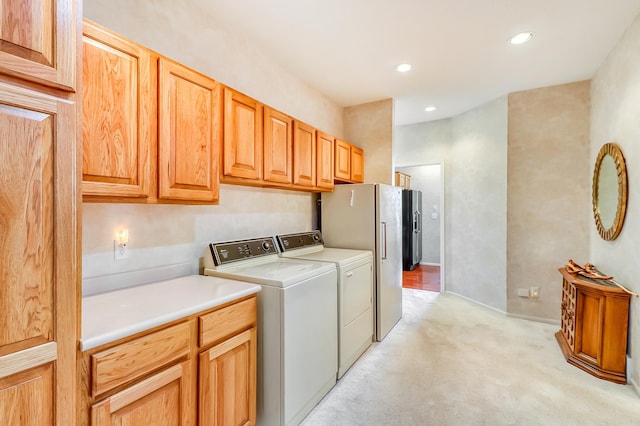 laundry room with washer and clothes dryer, light colored carpet, and recessed lighting