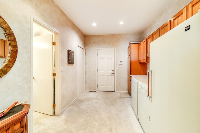 hallway featuring light carpet, independent washer and dryer, and recessed lighting