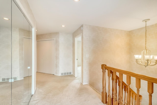 corridor featuring recessed lighting, visible vents, a notable chandelier, and carpet flooring