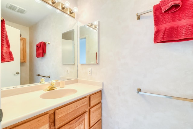 bathroom with vanity and visible vents