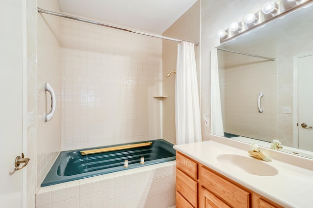 bathroom featuring tiled shower / bath combo and vanity