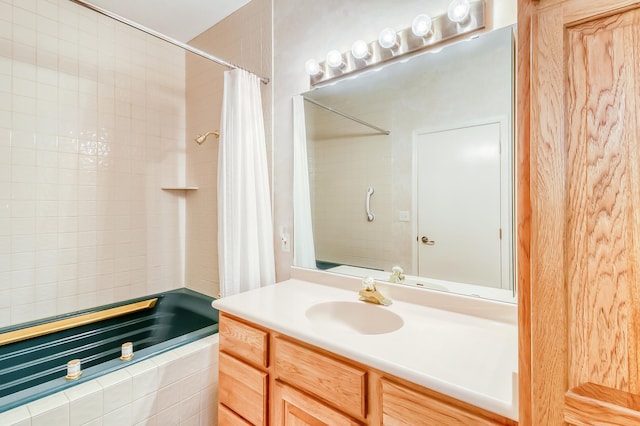 full bathroom featuring tiled shower / bath combo and vanity