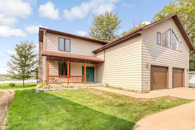 view of front of property featuring a water view, covered porch, a front lawn, and concrete driveway