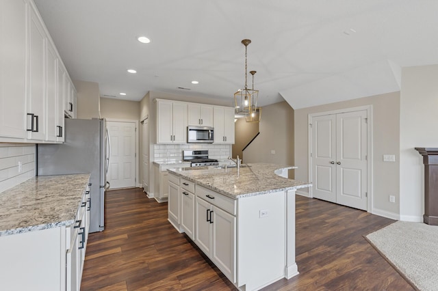 kitchen with dark wood-style floors, white cabinetry, appliances with stainless steel finishes, and recessed lighting