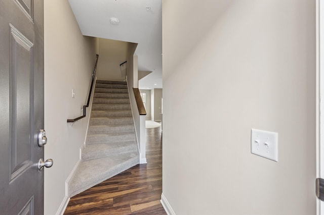 stairs with baseboards and wood finished floors