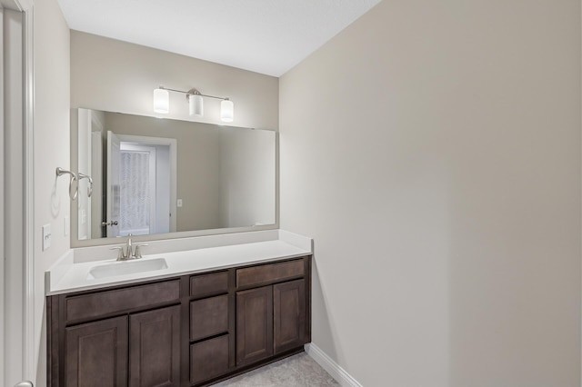 bathroom featuring vanity and baseboards