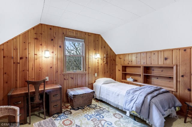 bedroom featuring lofted ceiling and wood walls