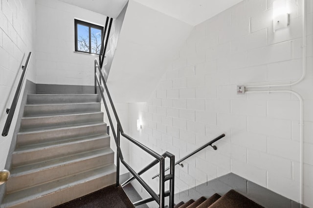 stairway with vaulted ceiling