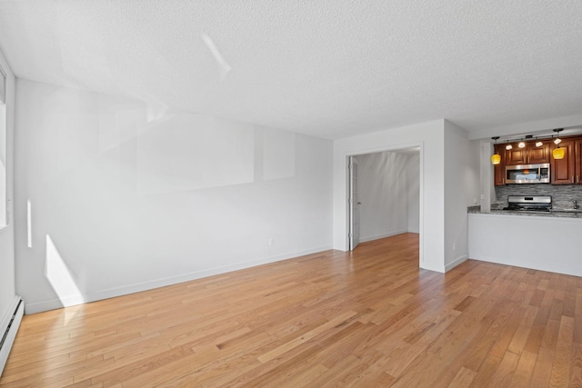 unfurnished living room featuring a baseboard heating unit, light wood-type flooring, a textured ceiling, and baseboards