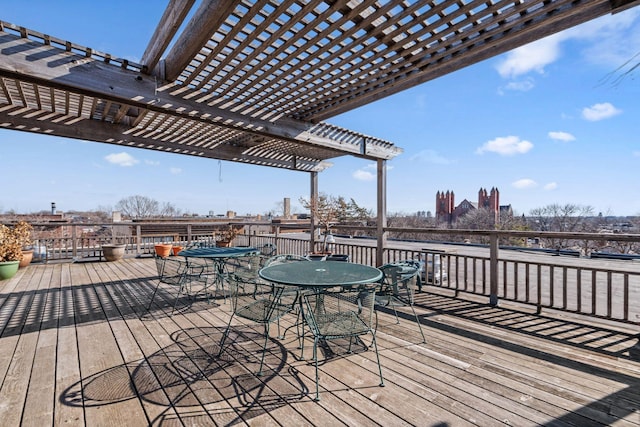 deck with outdoor dining area and a pergola