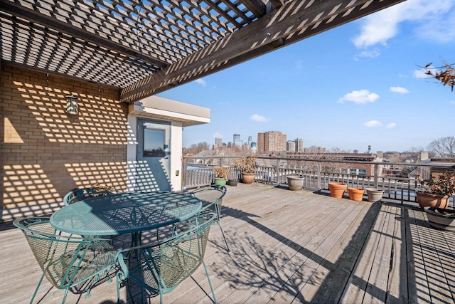 wooden deck with a pergola and a city view