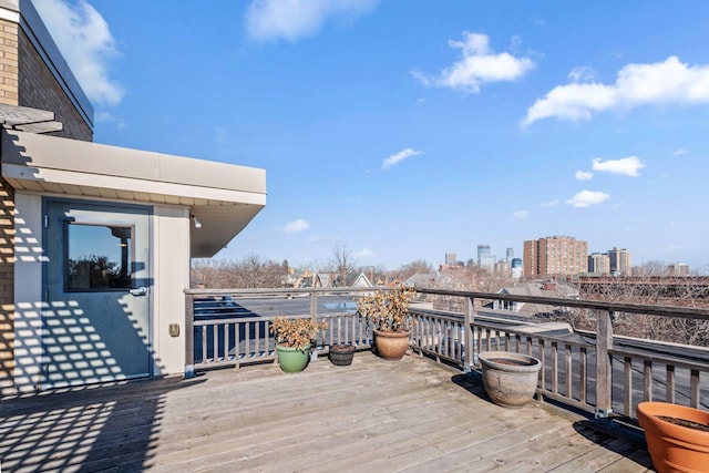 wooden terrace featuring a view of city