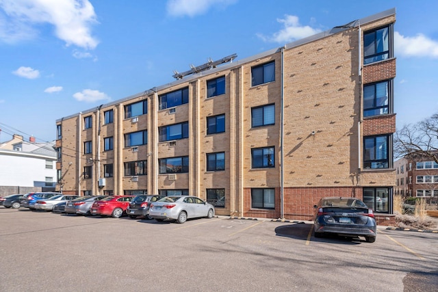 view of building exterior featuring uncovered parking