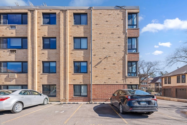 view of building exterior with uncovered parking