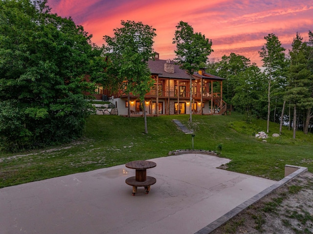 view of yard with an outdoor fire pit, stairs, and a patio