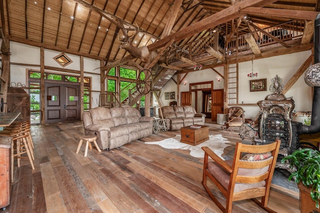 living area with high vaulted ceiling and wood-type flooring