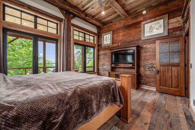 bedroom featuring wooden ceiling, wooden walls, french doors, beam ceiling, and hardwood / wood-style floors