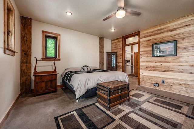 carpeted bedroom featuring ceiling fan, wooden walls, and recessed lighting