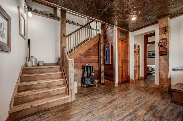 stairway with an ornate ceiling, baseboards, and hardwood / wood-style floors