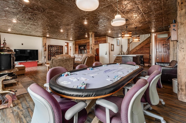 rec room with wood finished floors and an ornate ceiling