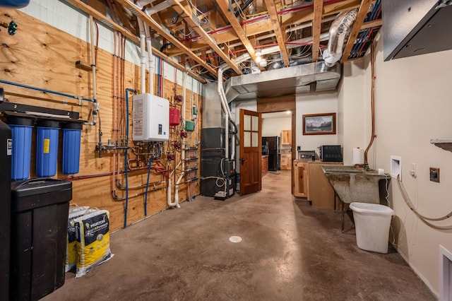 unfinished basement with heating unit, water heater, and black fridge