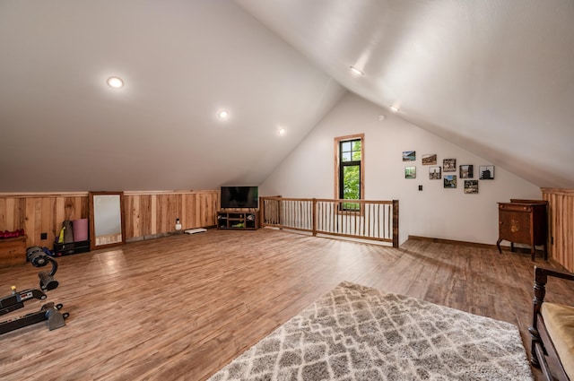 bonus room with lofted ceiling and wood finished floors