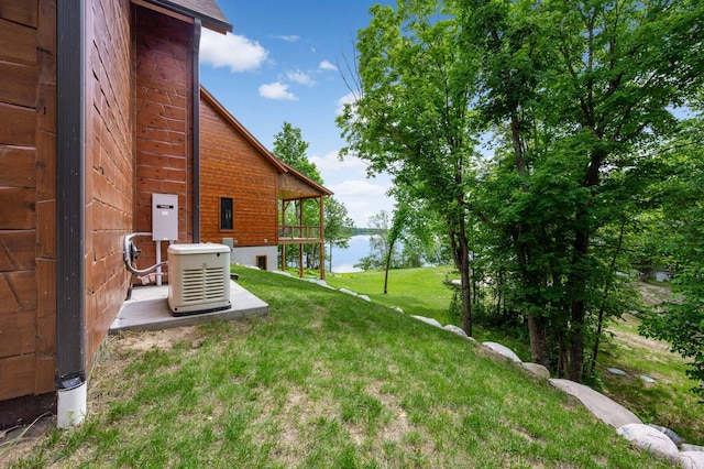 view of yard featuring a water view and a balcony