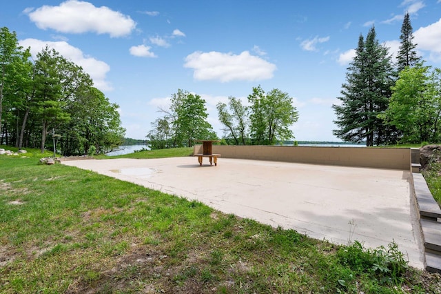 view of community featuring a water view and a lawn