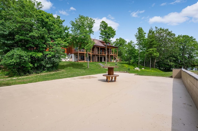 view of property's community featuring a wooden deck and a yard