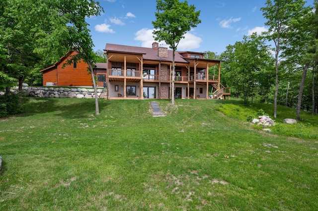 back of house featuring a yard, stairway, and a wooden deck